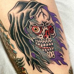 a tattoo with a skull and flames on it