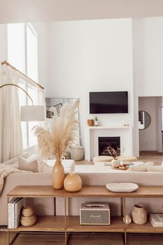 a living room filled with furniture and a fire place