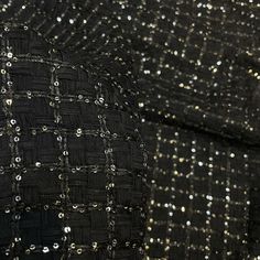 black and silver tweed fabric with sequins on the back, closeup view