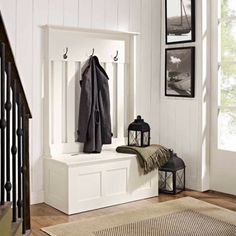 an entryway with a bench and coat rack