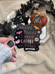 someone holding up a sticker that says hoccus pocus i need coffee to focus