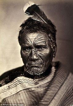 an old photo of a man with feathers on his head