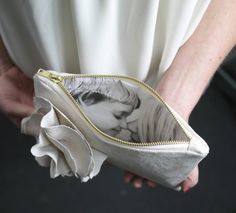 a woman holding a purse with a photo on it