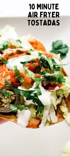 a hand holding up a tortilla filled with vegetables and sauce on top of it