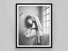 a black and white photo of a person in the bathroom with a towel on his head