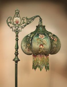 an ornate lamp with a green shade on it