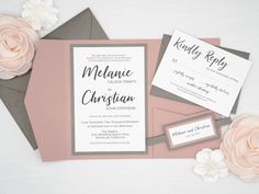 the wedding stationery is laid out on top of some pink and gray paper with flowers