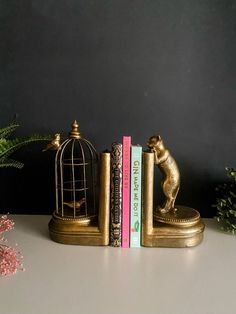 a bookend with two books and a dog figurine next to each other