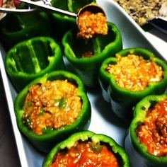 green peppers stuffed with meat and sauce in a white dish on a granite countertop