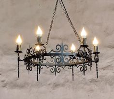 a chandelier with five candles hanging from it