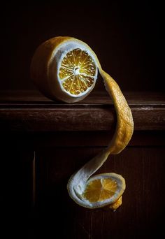 an orange sliced in half sitting on top of a table