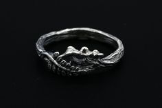 "Step into the whimsical charm of nature with our Mushroom and Fern Ring. Painstakingly handcrafted in sterling silver, this unique design features delightful mushrooms and a fern branch, all resting on a band with a realistic wood texture. This piece exudes the enchanting beauty of an undisturbed forest. This ring is an ideal choice for those who appreciate a piece that combines the playful charm of nature-inspired jewelry with the expertise of artisan craftsmanship. The mushrooms and fern, sym Hand Cast Nature-inspired Sterling Silver Jewelry, Unique Lost Wax Casting Jewelry For Wedding, Unique Wedding Jewelry In Lost Wax Casting, Unique Wedding Jewelry With Lost Wax Casting, Hand Forged Nature-inspired Ring, Nature-inspired Hand Forged Ring, Hand Cast Silver Jewelry For Anniversary, Artistic Hand Forged Sterling Silver Jewelry, Unique Hand Forged Sterling Silver Jewelry