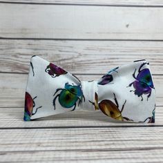 a close up of a bow tie with bugs on it