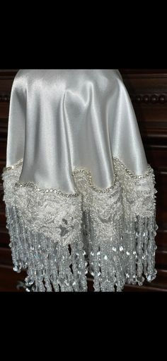 a white table cloth with beading on it