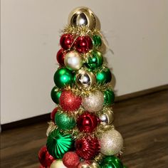 a small christmas tree made out of ornaments