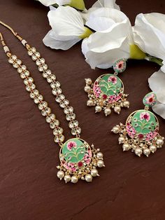 Gorgeous gold plated. Beautiful and elegant Kundan and Meenakari Necklace Perfect for Indian weddings. Size- Adjustable Premium Quality and High craftsmanship Gorgeous 24 K gold plated. All the raw material used in this product is of high quality and is handcrafted with love. Premium Quality and High craftsmanship 100% Satisfaction Guarantee: Long Lasting Plating, High-Quality Stones. Gifting: This pair of charming necklace and earrings come in a beautiful gift box, making it an ideal gift for b Bollywood Style Temple Necklace With Gota Work As Gift, Bollywood Style Temple Necklace With Gota Work, Festive Kundan Necklace With Meenakari, Festive Round Kundan Necklace With Meenakari, Round Kundan Necklace With Meenakari As Gift, Kundan Meenakari Necklaces For Puja, Temple Jewelry Necklace With Gota Work As Gift, Temple Jewelry Necklace With Gota Work, Temple Jewelry Bridal Necklace With Gota Work