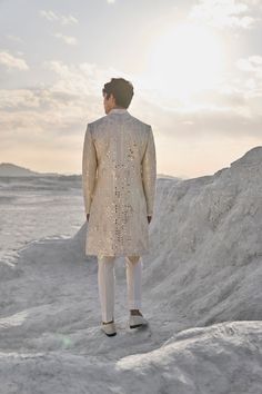 This set features all over mirror work on a raw silk base. It is paired with an off-white silk kurta and an off-white straight pants. Complementing stole is also available.From Seema Gujral's Elements collection. DELIVERY TIMEPlease allow 6-8 weeks for your outfit to arrive. FABRIC DETAILSSherwani - Raw Silk Kurta - Silk Trouser - Stretchable TR Professional cleaning only. White Sherwani, Raw Silk Kurta, Raw Silk Embroidery, Seema Gujral, Embroidery Mirror, Silk Kurta, White Mirror, Vogue India, Silk Trousers