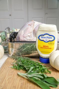 the ingredients to make blue plate chicken are displayed on a cutting board, including onions and garlic