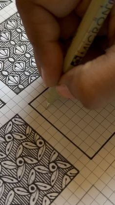 someone is drawing designs on paper with a pencil