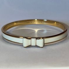 Kate Spade “Take A Bow” Cream Bracelet. 12k Plated Gold/Enamel. Engraved Signature Inside. Slip On, 2.4” Diameter. Never Worn, Great Condition. Bag Included. Bow Bracelet, Bow Necklace, Jewelry Accessories Ideas, Jewelry Lookbook, Spade Jewelry, Kate Spade Jewelry, Gold Enamel, Cream And Gold, Simple Jewelry