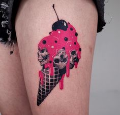 a woman's thigh with skulls and ice cream on it