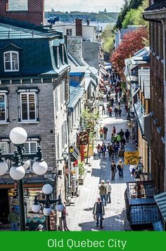 an old quebec city street with lots of people walking down it and the words old quebec city written in green