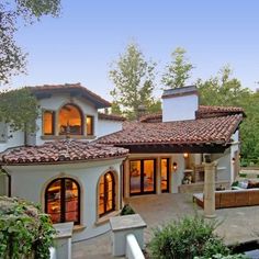 a large house with lots of windows and landscaping