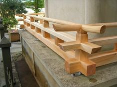 a wooden bench sitting on the side of a building