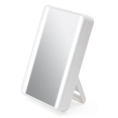 a white lighted mirror sitting on top of a table