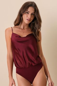 Looking flawlessly chic is easy with the Lulus Emmerson Burgundy Satin Sleeveless Cowl Neck Bodysuit! Lightweight textured woven satin shapes this slinky bodysuit with skinny adjustable straps, a flowy cowl neckline, and a fitted sleeveless bodice with an elasticized back. Cheeky bottoms have two snap closures. Fit: This garment fits true to size. Length: Size medium measures 31.5" from adjustable straps to hem. Bust: Great for any cup size. Waist: Not Fitted - comfortable room throughout midsec Elegant Sleeveless Bodysuit With Built-in Bra, Chic Sleeveless Bodysuit With Built-in Bra, Sleek Summer Bodysuit With Spaghetti Straps, Elegant Bodysuit With Adjustable Straps For Night Out, Chic Bodysuit With Spaghetti Straps, Chic Cami Bodysuit For Party, Solid Spaghetti Straps Bodysuit For Night Out, Solid Bodysuit With Spaghetti Straps For Night Out, Chic Spaghetti Strap Bodysuit For Date Night