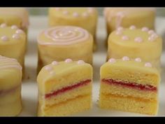 there are many different colored desserts on the tray