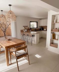 an open kitchen and dining room with white walls