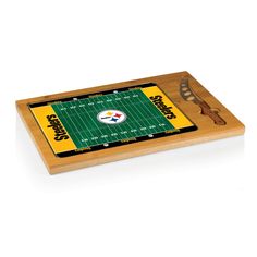 a wooden cutting board with a football field on it