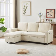 a living room with a white couch and rug