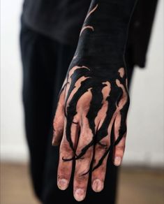 a person with black paint on their hands