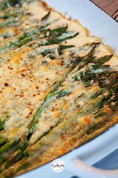 a casserole dish with asparagus and cheese