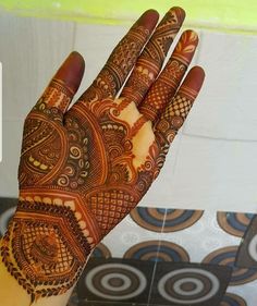 a person's hand with henna tattoos on it