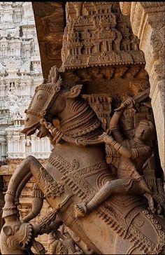 an intricately carved statue on the side of a building