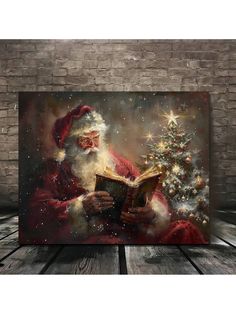 a painting of santa reading a book next to a christmas tree on a wooden floor