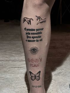 a man's leg with tattoos and words on it, including a butterfly in the center