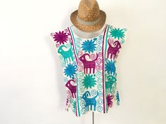 "This beautiful blouse is traditional Oaxaca, is a loose blouse, made of a pattern of very basic and comfortable design. It can be worn with a skirt, jeans and looks spectacular, with bohemian touch, hippie, a relaxed style. It is made of 100% cotton blanket fabric. Hand-embroidered by talented Oaxacan hands. Size Medium Width 20\" Length 24.5\"" Summer Cotton Tops With Motif, Folk Style Embroidered Beach Tops, Summer Cotton Top With Motif, Bohemian Sleeveless Top With Geometric Embroidery, Folk Style Multicolor Embroidered Summer Tops, Summer Folk Style Tops For Festivals, Folk Style Multicolor Embroidery Summer Tops, Folk Style Tops For Summer Festivals, Summer Festival Embroidered Top With Geometric Patterns