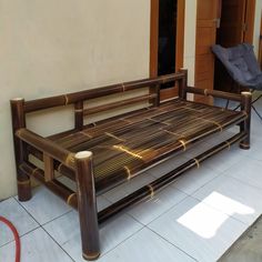 a wooden bench sitting on top of a tiled floor