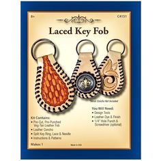 three key fobs with different designs and colors are shown in front of a blue frame