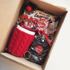 an open box with candy, coffee and other items in it sitting on a table