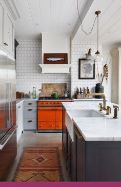 a kitchen with orange cabinets and white counter tops