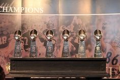 four trophies are lined up on a piano