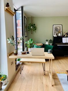 a living room filled with furniture and a laptop computer on top of a wooden table