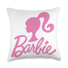 a pink and white pillow with the word barbie on it's side, in front of a silhouette of a woman