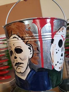 a bucket with a painting of a man's face on it