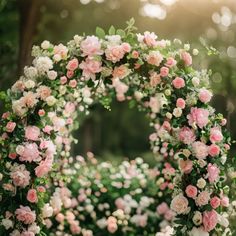 a bunch of pink and white flowers on a green wreath with greenery in the background